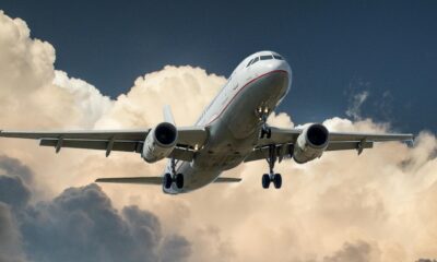 flying airplane with clouds behind