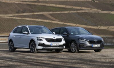 A front three-quarter shot of the new Skoda Scala and Kamiq parked outdoors.