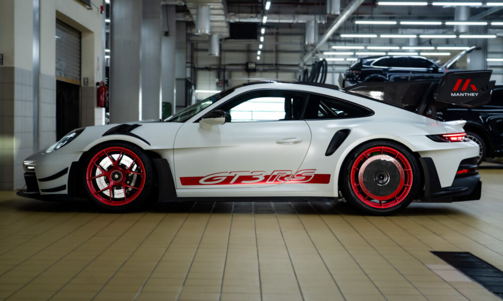 A side-angle shot of a 992 generation Porsche 911 GT3 RS equipped with the Manthey Performance kit