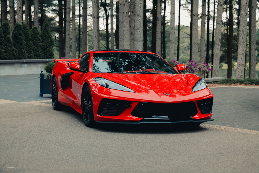 A front-three-quarter shot of a red Chevy Corvette parked outdoors