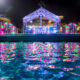 LEGOLAND Dubai Water Park’s Neon Nights event with a glowing stage, vibrant neon lights reflecting on the wave pool, and themed LEGO decorations.