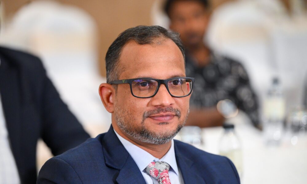 Professional headshot of Moossa M. Alavi, Founder & CEO of Techbot ERP, wearing dark-rimmed glasses and navy business suit with patterned tie.RetryClaude can make mistakes. Please double-check responses.