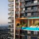 Modern residential tower with sky pool and Dubai skyline views featuring contemporary architecture and luxury amenities at sunset.