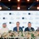 Four executives at ATARA Development, Sheraton, and Marjan partnership signing ceremony with floral arrangements and branded backdrop wall.