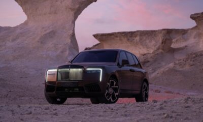 A front three-quarter shot of the Rolls-Royce Black Badge Cullinan Series II Desert Sunset parked in the desert.