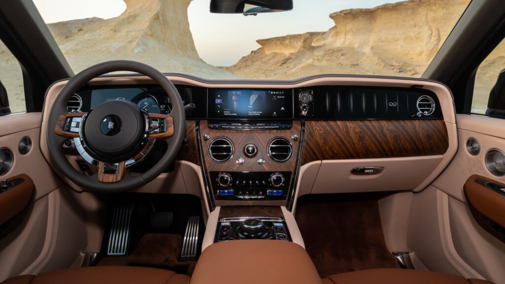 Interior shot of the Rolls-Royce Black Badge Cullinan Series II Desert Sunset parked in the desert.