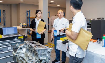 a side-angle shot of automotive professionals attending a training session
