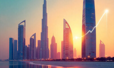 Modern Gulf city skyline at sunrise with a stylized upward growth line symbolizing economic and financial growth.