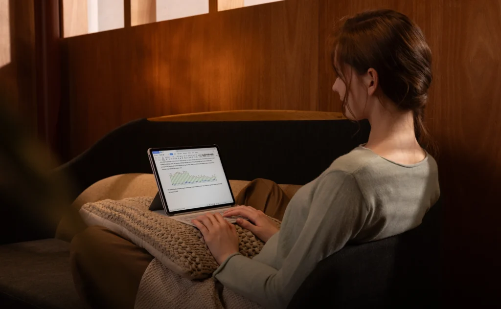 A woman holding the a product image of the HUAWEI MatePad 11.5 and reading something on it