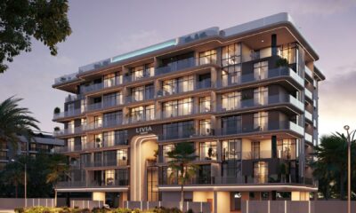 Livia Residences six-storey modern residential building with glass facade, warm lighting, and landscaped surroundings in Dubai South development.