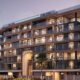 Livia Residences six-storey modern residential building with glass facade, warm lighting, and landscaped surroundings in Dubai South development.