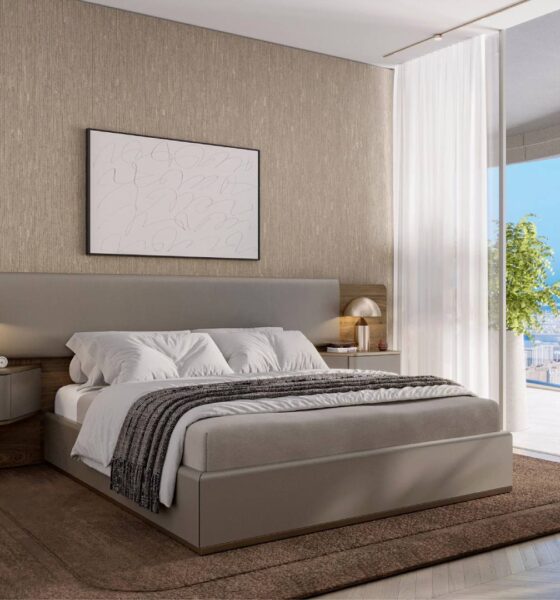 Modern master bedroom with contemporary Pininfarina furniture, textured wall panels, panoramic city views, and neutral color scheme in luxury Dubai apartment.