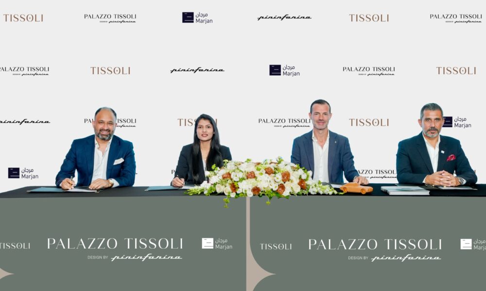 Tissoli, Pininfarina, and Marjan executives signing AED 1.2 billion Palazzo Tissoli partnership agreement at formal ceremony with branded backdrop.