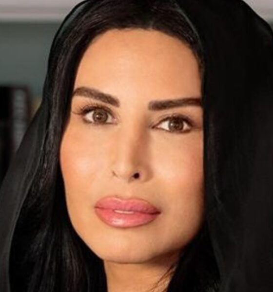 Rasha Al Mubarak, Founder and Chairwoman of Music Nation, portrait in black abaya against modern office interior background.