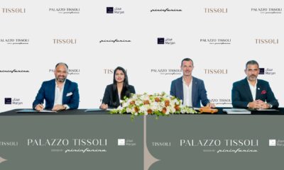 Tissoli, Pininfarina, and Marjan executives signing AED 1.2 billion Palazzo Tissoli partnership agreement at formal ceremony with branded backdrop.