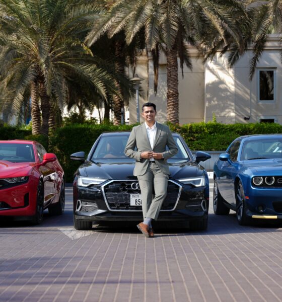 A front-angle shot of Harshvardhan Singh, Business Head, CARIVA standing in front of an Audi A6, Chevy Camaro and Dodge Charger