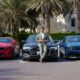 A front-angle shot of Harshvardhan Singh, Business Head, CARIVA standing in front of an Audi A6, Chevy Camaro and Dodge Charger