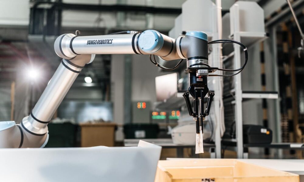 A wide angle shot of a robotic arm by Yango Tech in an industrial setup