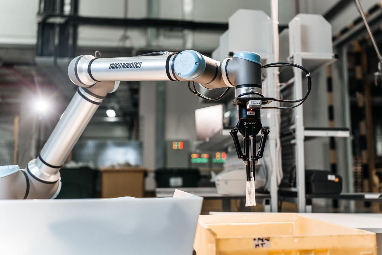 A wide angle shot of a robotic arm by Yango Tech in an industrial setup