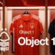 Object 1 branded Nottingham Forest football jerseys displayed on hangers - white away kit, red home kit, and black goalkeeper kit with Forest club logo