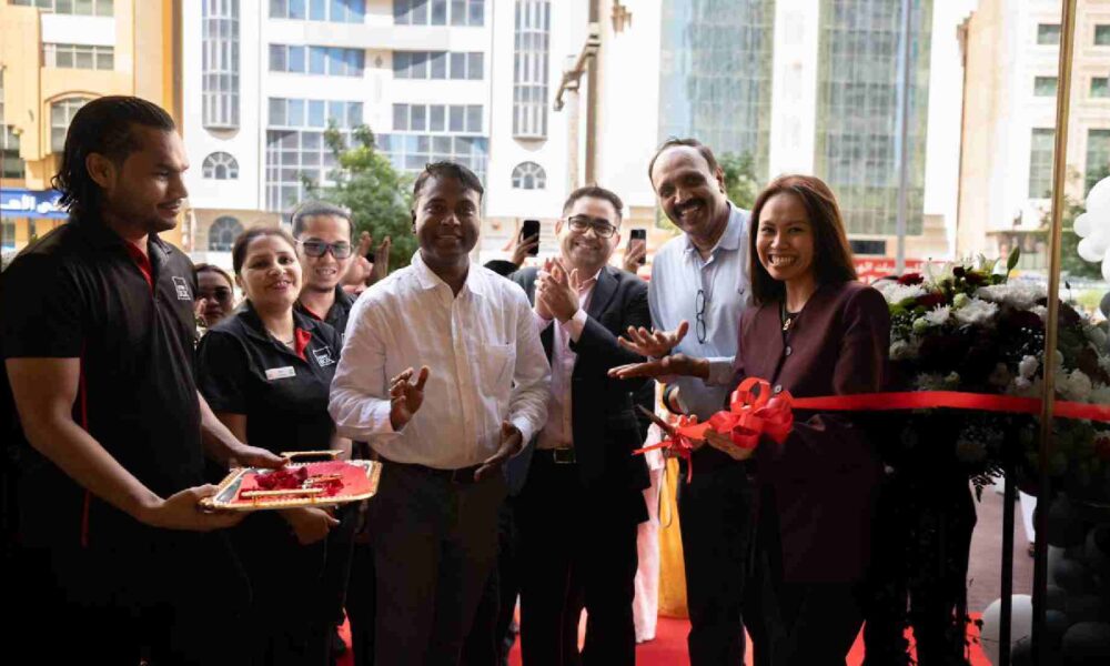 Ribbon-cutting ceremony with smiling guests and team members celebrating the opening event.