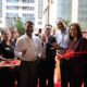 Ribbon-cutting ceremony with smiling guests and team members celebrating the opening event.