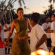 Guests dancing at sunset beach celebration with traditional Maldivian performers at Sun Siyam resort