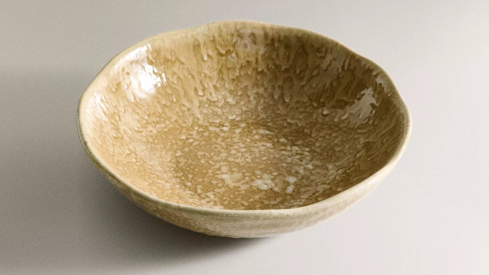 Handcrafted ceramic bowl with speckled earthy glaze finish from Zara Home Autumn Winter 2025 collection.
