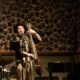 Three-piece jazz trio performing live at Cucina The Palm during Jazz and Juice Nights, featuring upright bass, piano, and drums against decorative wall backdrop.