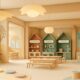 The Baby Atelier-designed children's learning center featuring warm wood tones, role-play zones with miniature supermarket and cooking stations, circle time seating, and world map for therapeutic healthcare environment.