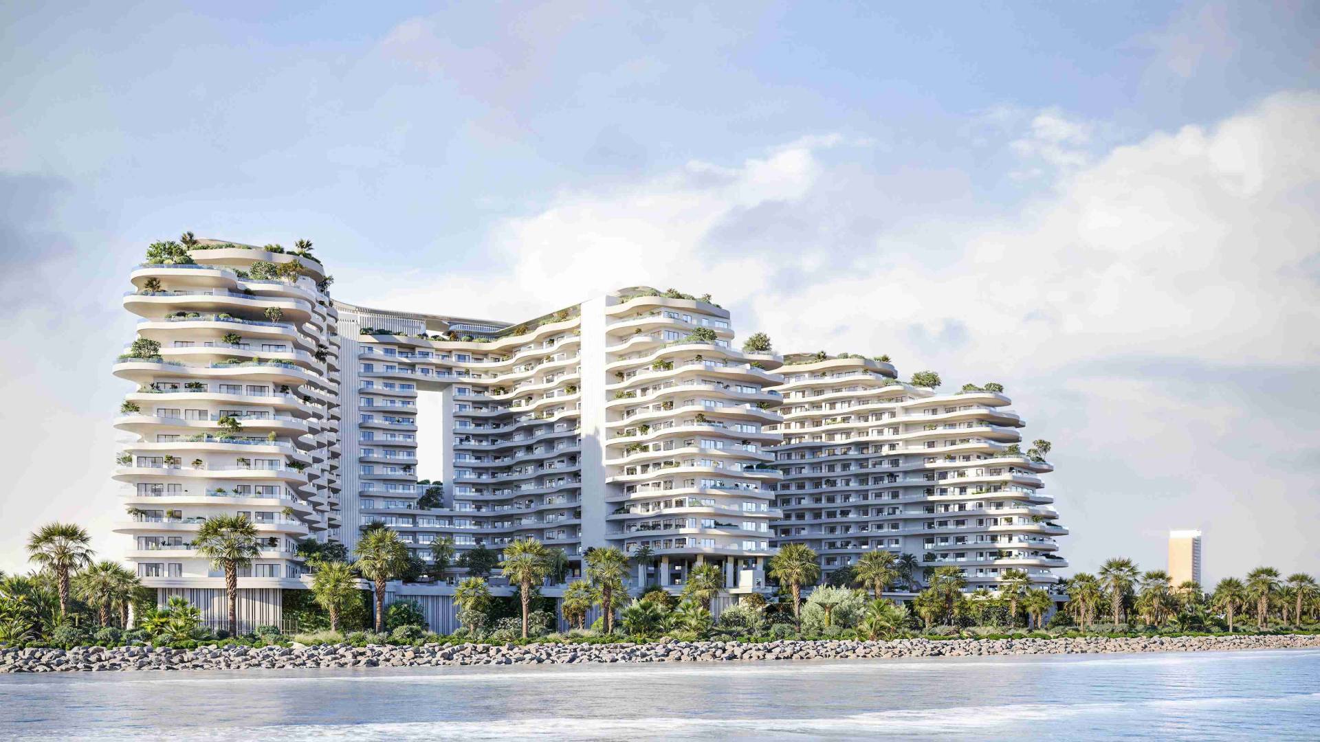 Miraggio luxury waterfront development by Source of Fate on Al Marjan Island, Ras Al Khaimah, featuring curved architecture with landscaped terraces and beachfront access.