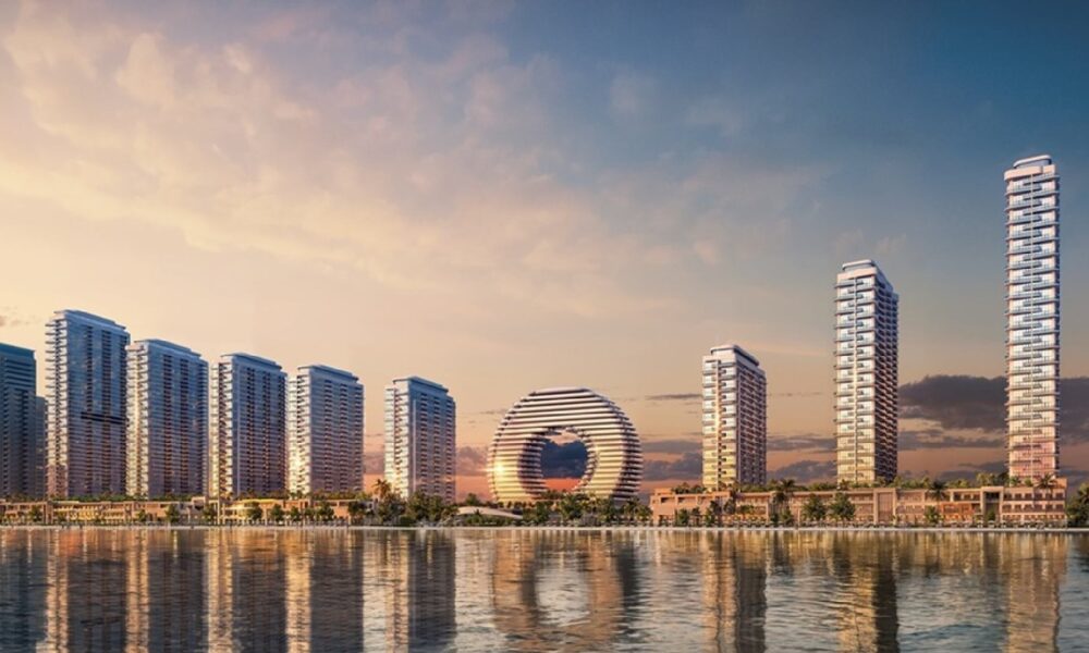 Downtown UAQ Sobha Realty waterfront master development rendering showing residential towers and circular landmark building at sunset
