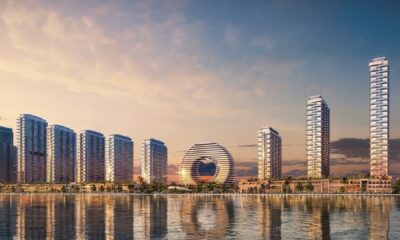 Downtown UAQ Sobha Realty waterfront master development rendering showing residential towers and circular landmark building at sunset