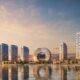 Downtown UAQ Sobha Realty waterfront master development rendering showing residential towers and circular landmark building at sunset