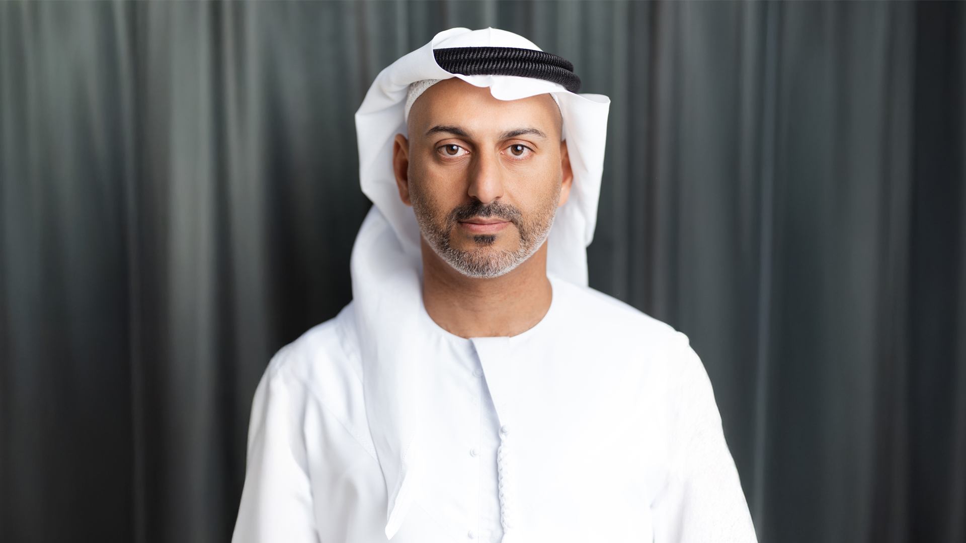 Professional portrait of Francis Alfred, Managing Director of Sobha Realty, wearing traditional white kandura and ghutra in formal business setting