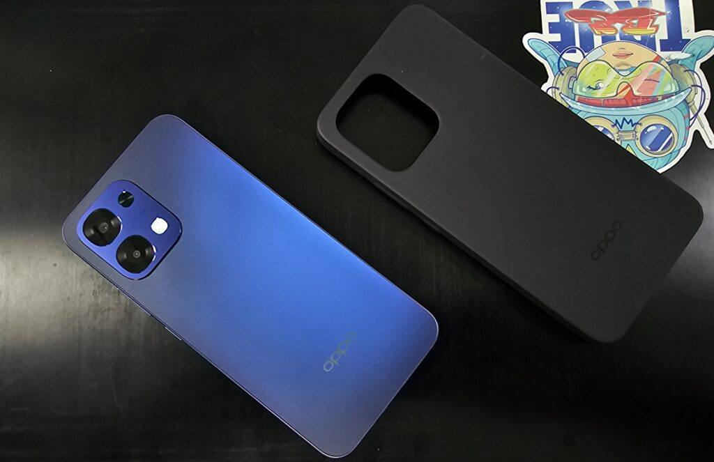 A top-angle shot of an Oppo A6 5G and its case placed on top of a laptop