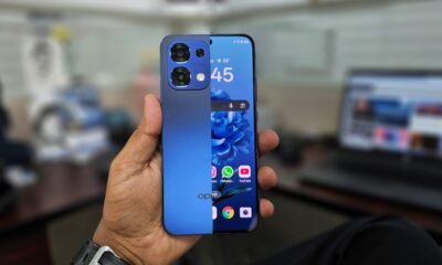 An combined shot of the front and back of a Blue Oppo A6 Pro 5G held in hand.