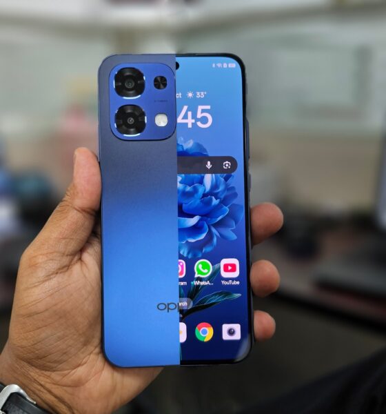 An combined shot of the front and back of a Blue Oppo A6 Pro 5G held in hand.