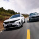 A front-angle action shot of two VOYAH FREE SUVs driven parallelly on a scenic road