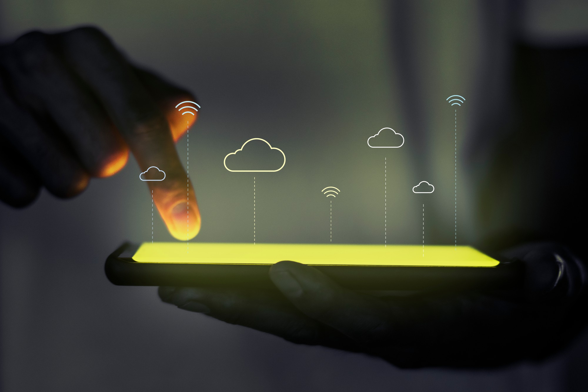 A visualization of cloud platforms portrayed by a mobile screen touched by the person holding it while abstract cloud icons are floating above it,