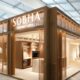 Sobha Furniture exhibition booth with wooden facade and illuminated display at design trade show