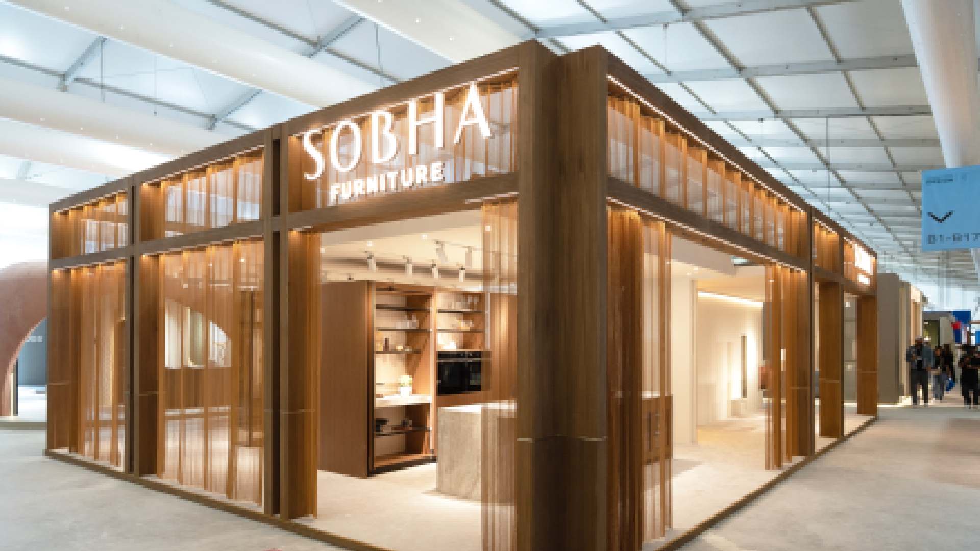 Sobha Furniture exhibition booth with wooden facade and illuminated display at design trade show
