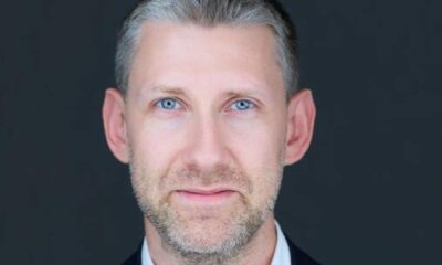 Professional headshot of Rafal Hyps, Chief Executive Officer of Intelyse, against dark background wearing business attire.