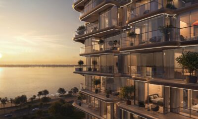 Treppan Serenique Residences exterior view showing modern dual tower design with curved balconies and waterfront location at sunset