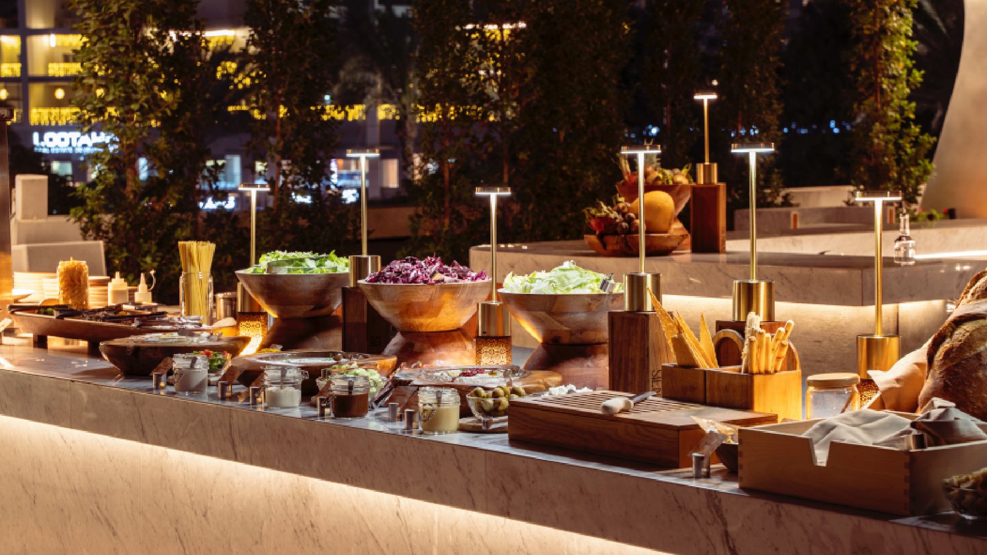 Grill by ME outdoor buffet station at ME by Meliá Dubai with fresh salads, grills, and interactive dining setup at poolside terrace