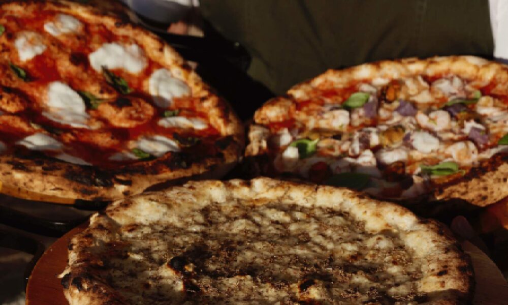 Wood-fired pizzas with fresh mozzarella and toppings at Acquasale by CUCINA Italian restaurant