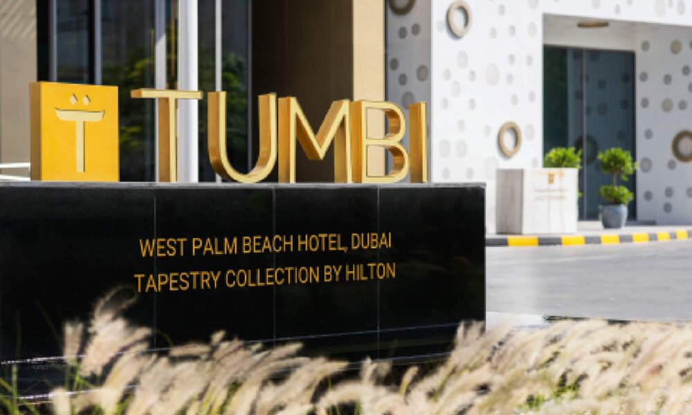 Tumbi restaurant golden signage at West Palm Beach Hotel Dubai, Tapestry Collection by Hilton entrance