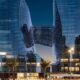 ME By Meliá Dubai Opus building illuminated at dusk with MICHELIN 2025 logo, showcasing Zaha Hadid's distinctive architectural design