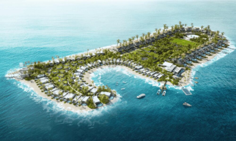 Aerial view of heart-shaped tropical island development with white villas, palm trees, and turquoise waters