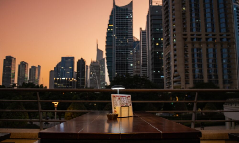 Kima Izakaya outdoor terrace table at sunset with JLT Dubai skyline view in background
